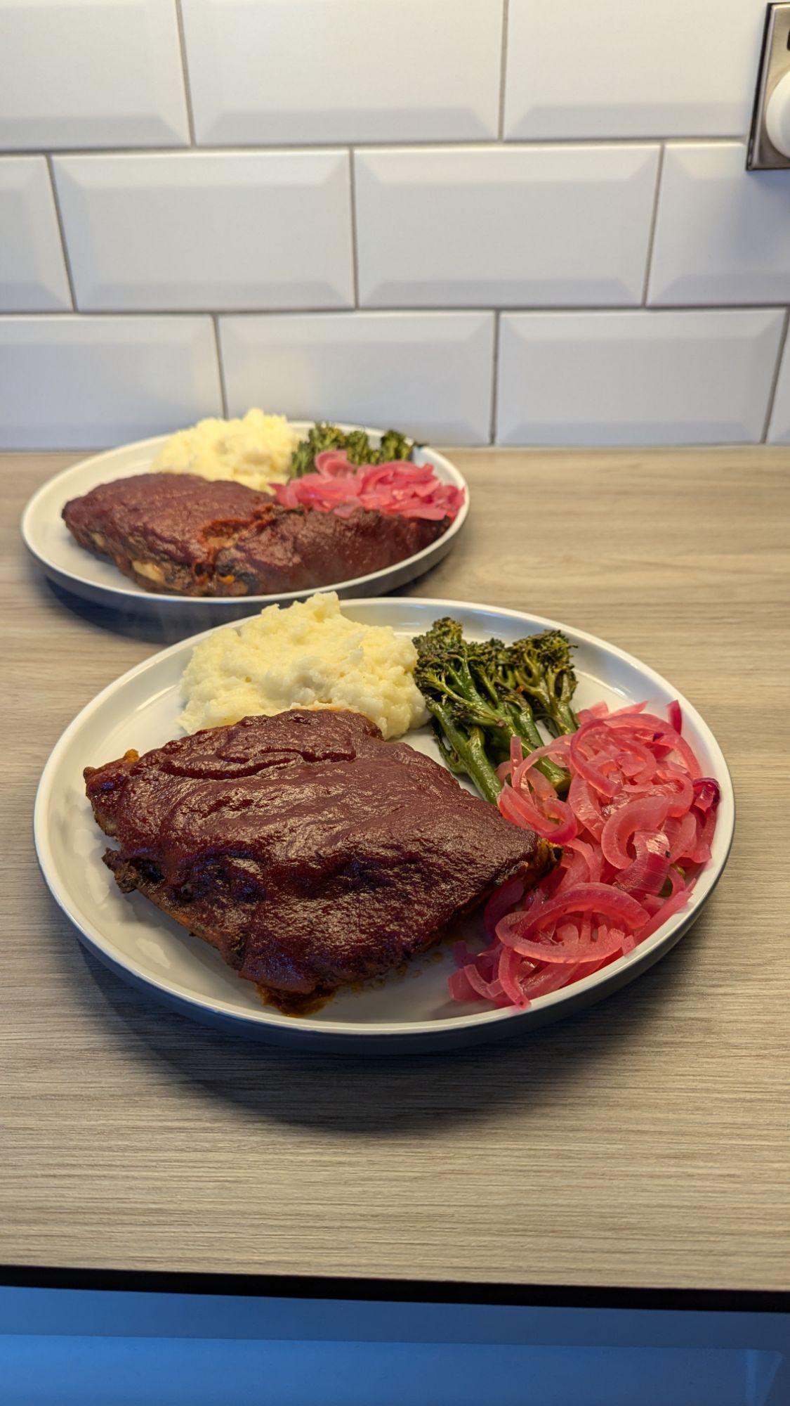 Sweet Barbeque Pork Ribs, Roasted Garlic Mash Potato, Lemon and Garlic Tenderstem Broccoli and Pickled Red Onion
