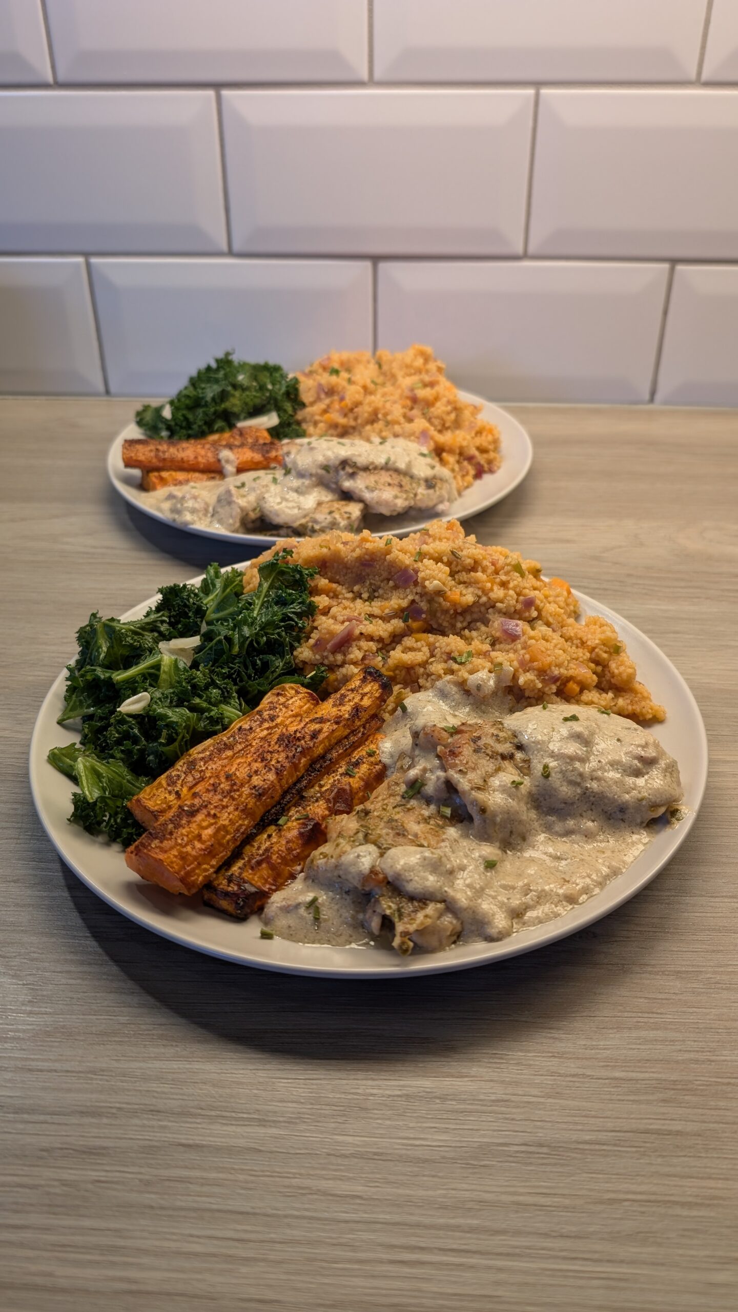 Chicken Thighs Cooked in a Tahini Sauce, Balsamic Vegetable Cous Cous, Sumac Carrots and Steamed Garlic Kale