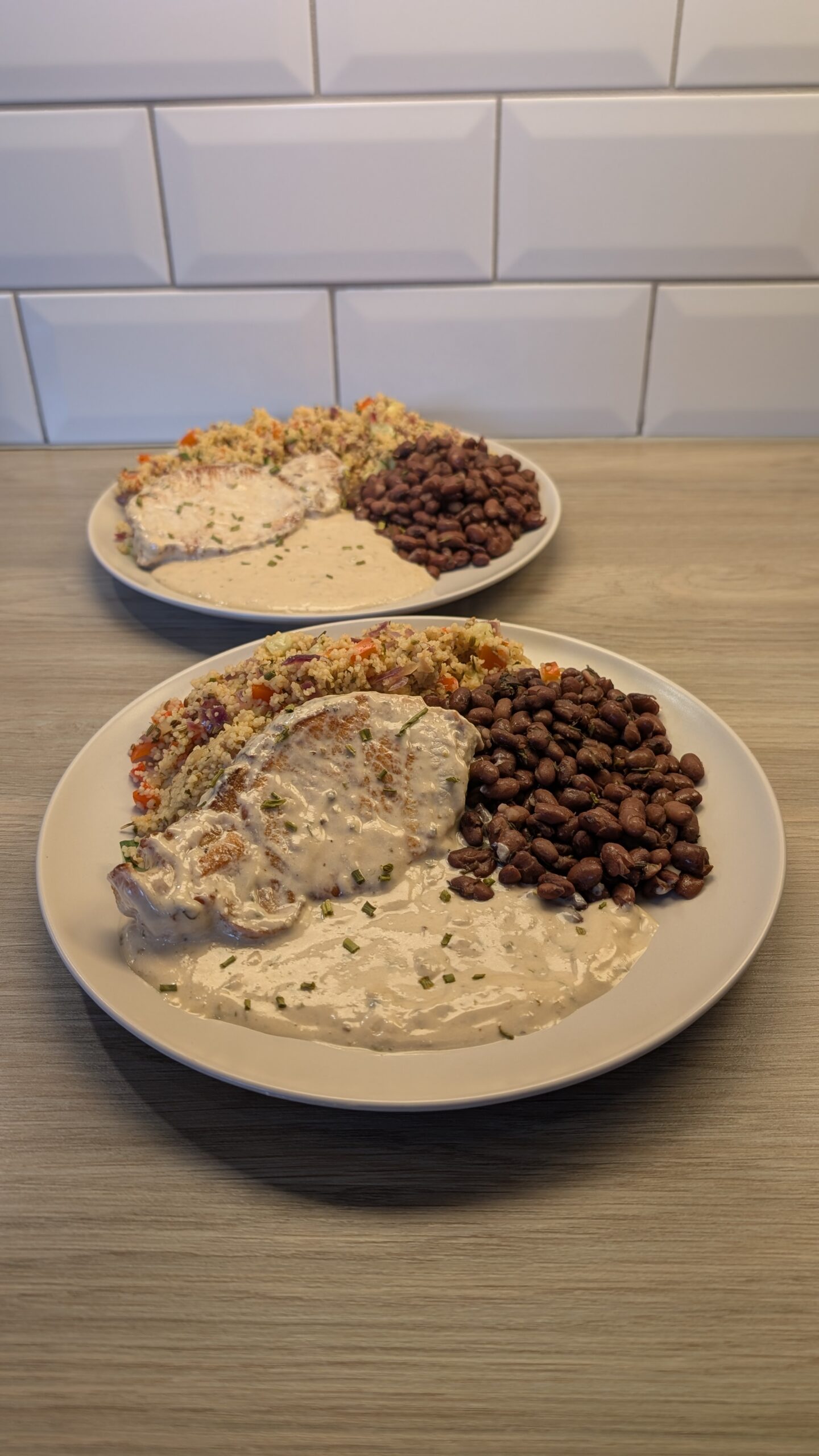 Pan Seared Pork Loin Finished in a Garlic Pan Sauce with Vegetable Cous Cous and Black Beans