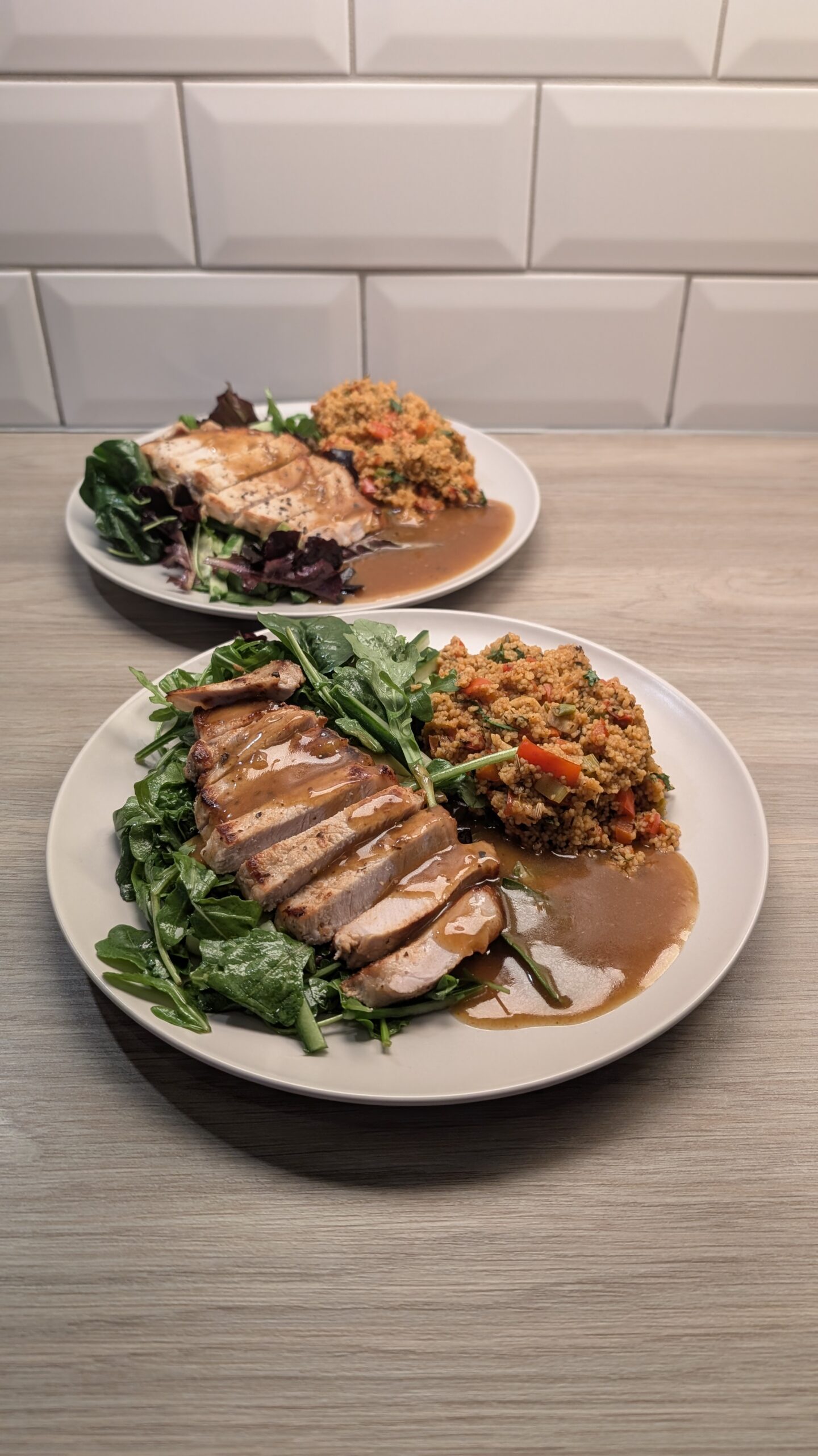 Chilli Marinated Pork Loin, Smokey Red Pepper Cous Cous and a Rocket and Cucumber Salad in a Honey Vinaigrette with a Spicy Chicken Reduction