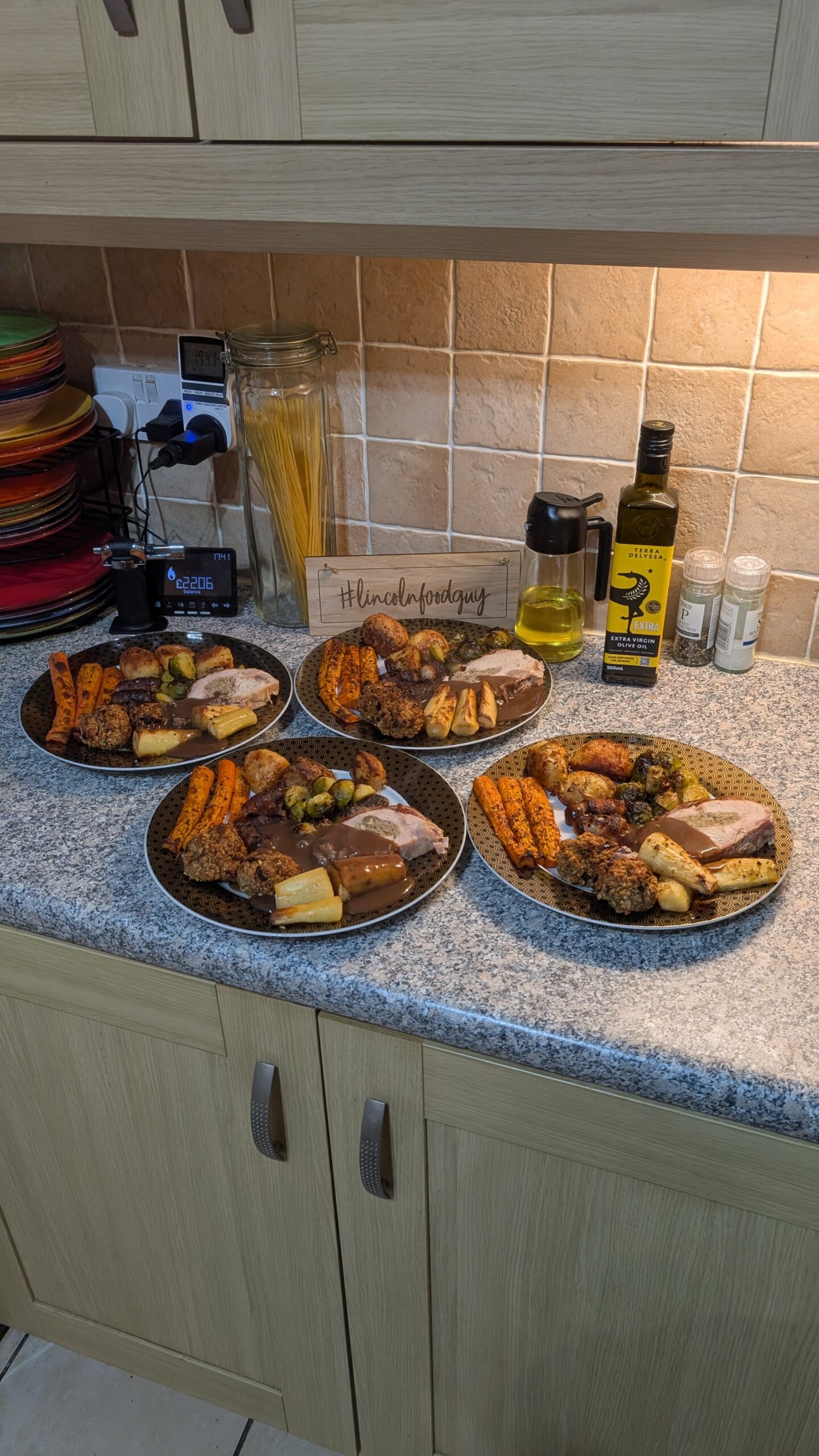 Three Bird Roast, Garlic and Rosemary Roast Potatoes, Honey Roasted Parsnips, Roasted Brussel Sprouts and Carrots, Pigs and Blankets and Stuffing with a Red Wine Gravy