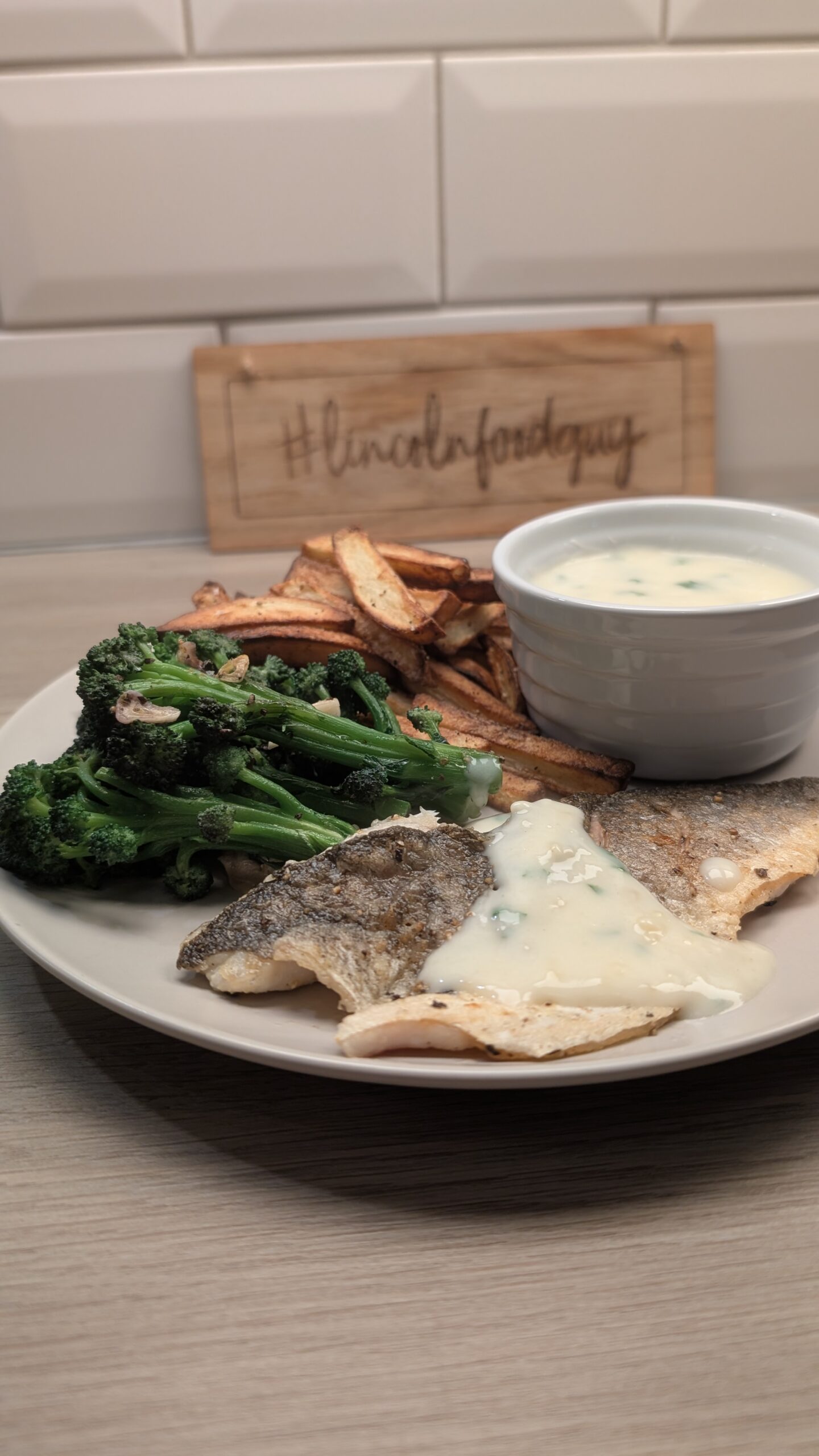 Sea Bass, Chips and Garlic Purple Sprouting Broccoli with a Lemon and Coriander Sauce