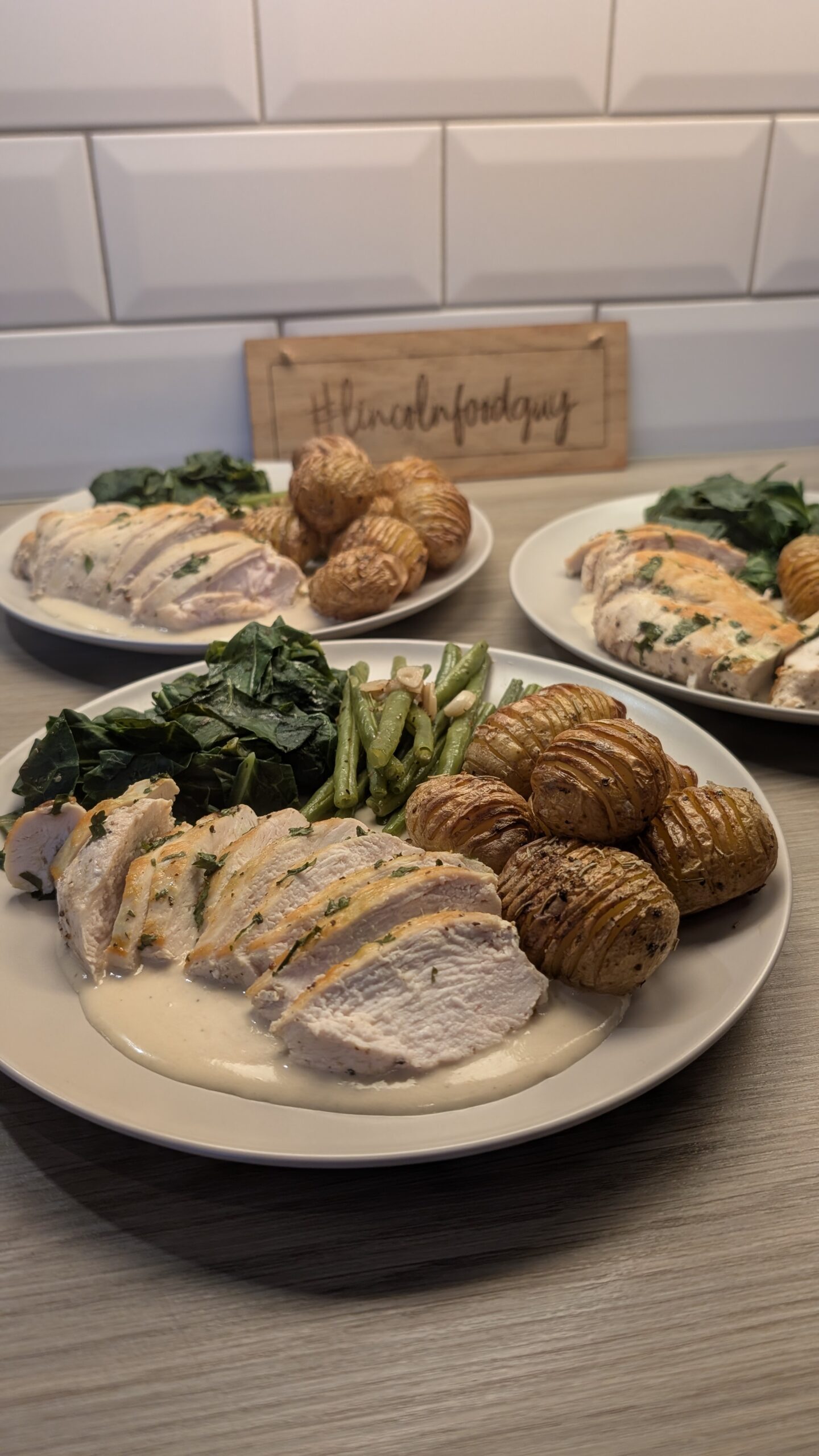 Butter and Coriander Chicken Breast, Rosemary Hassleback New Potatoes, Garlic Green Beans and Minted Spring Greens with a Cream Sauce